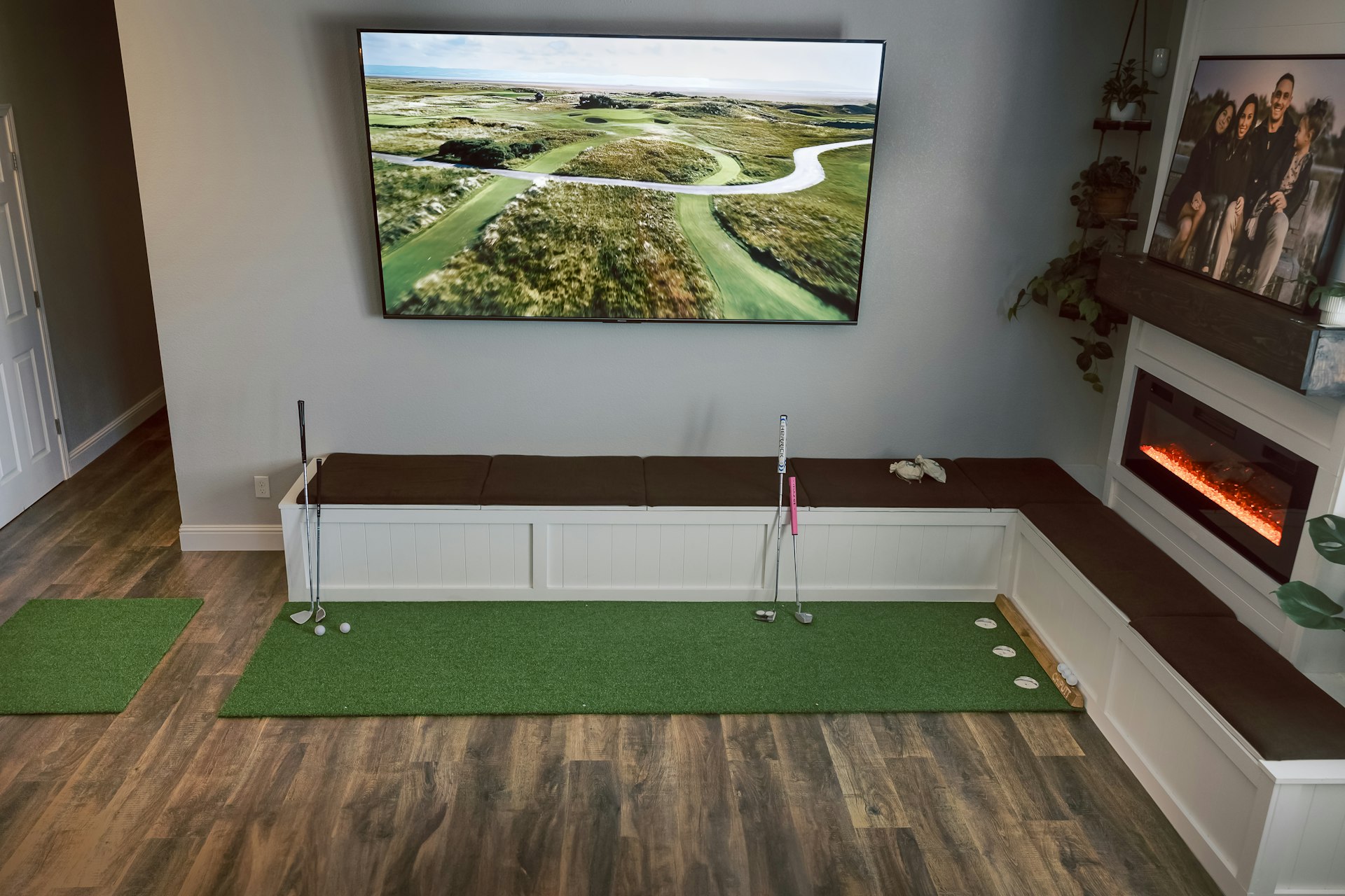Home golf room with a putting green and a course on screen